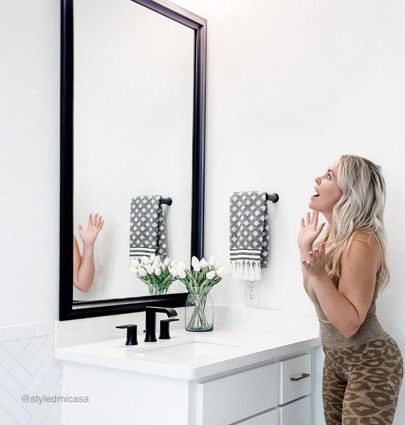 Woman amazed at her new MirrorMate mirror frame install