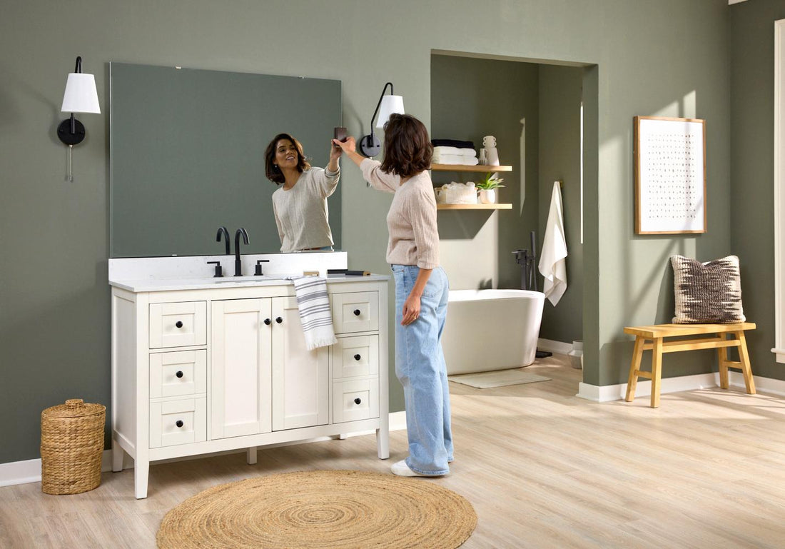 Woman inspecting her deteriorating bathroom mirror