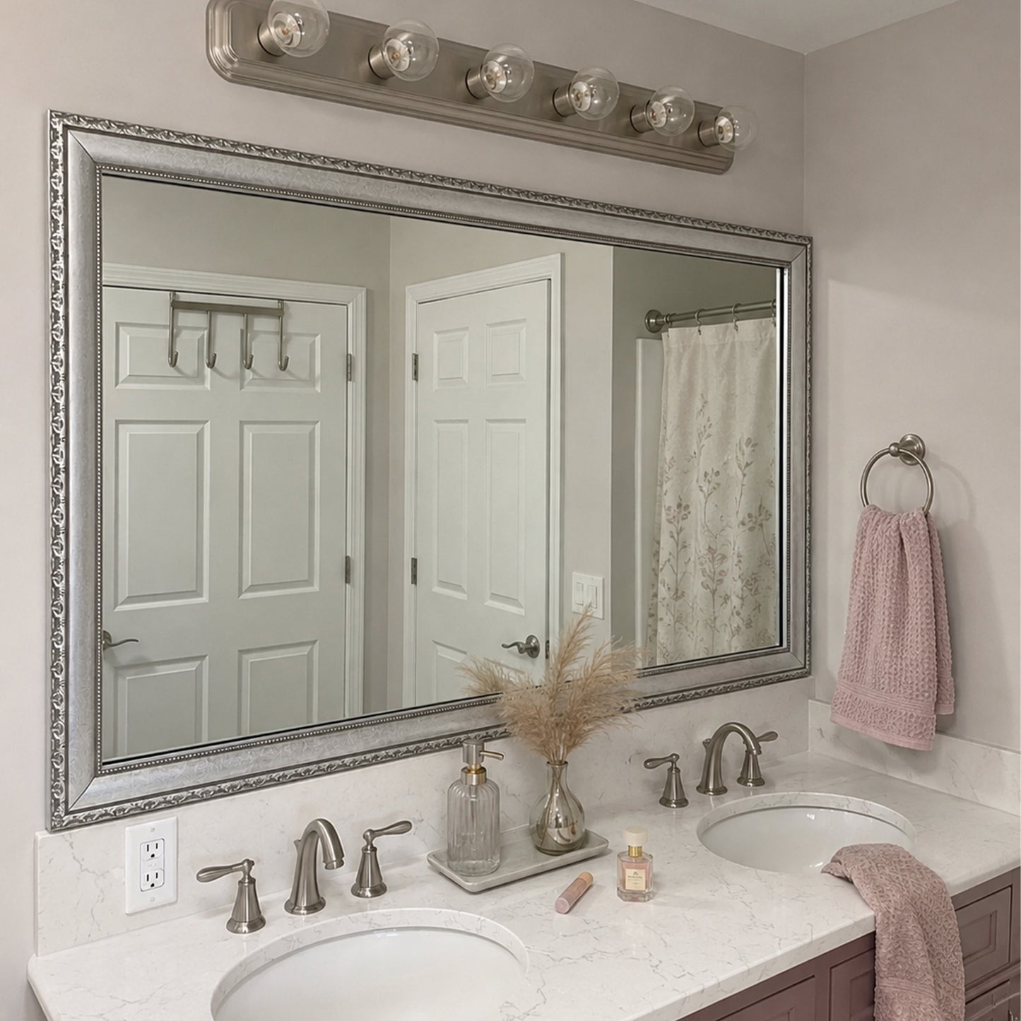 Bellemeade Vintage Silver MirrorMate frame above a double vanity in a soft pink and white bathroom