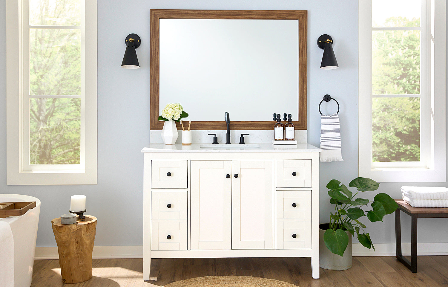 White Vanity in Bathroom with Wood Framed Mirror Hiding the Mirror Clips