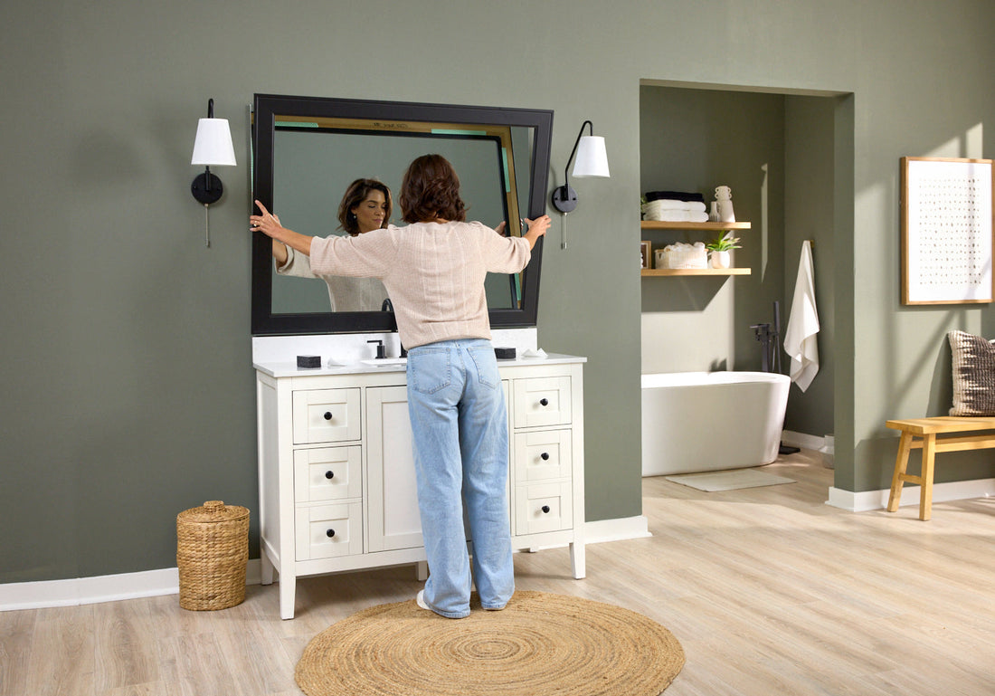Woman Adding a MirrorMate Frame to Her Vanity Sink That Has Mirror Clips