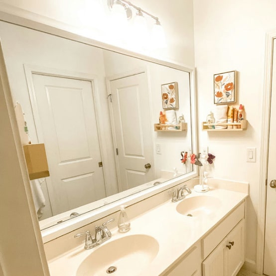 White Bathroom with a Decorative Mirror Frame