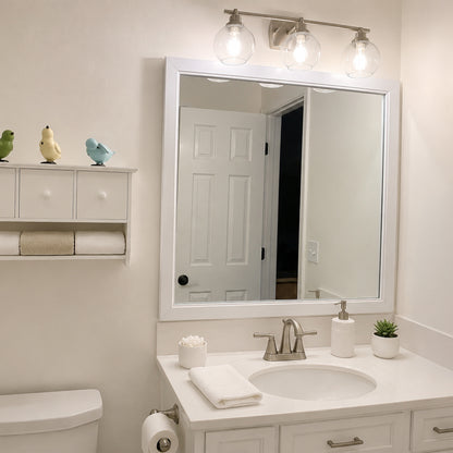 Annandale White Slim MirrorMate frame on a single vanity mirror in a bright white bathroom