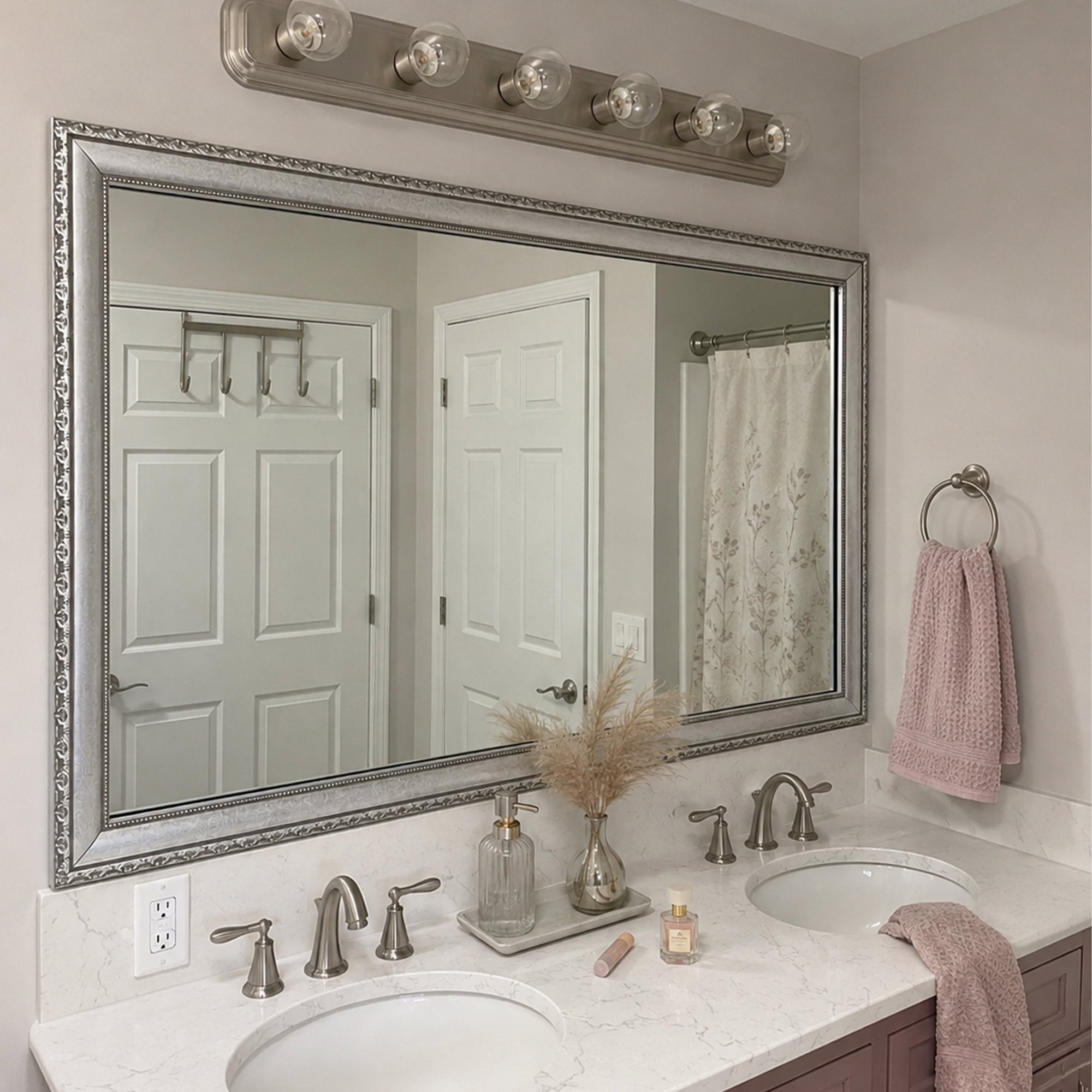 Bellemeade Vintage Silver MirrorMate frame above a double vanity in a soft pink and white bathroom