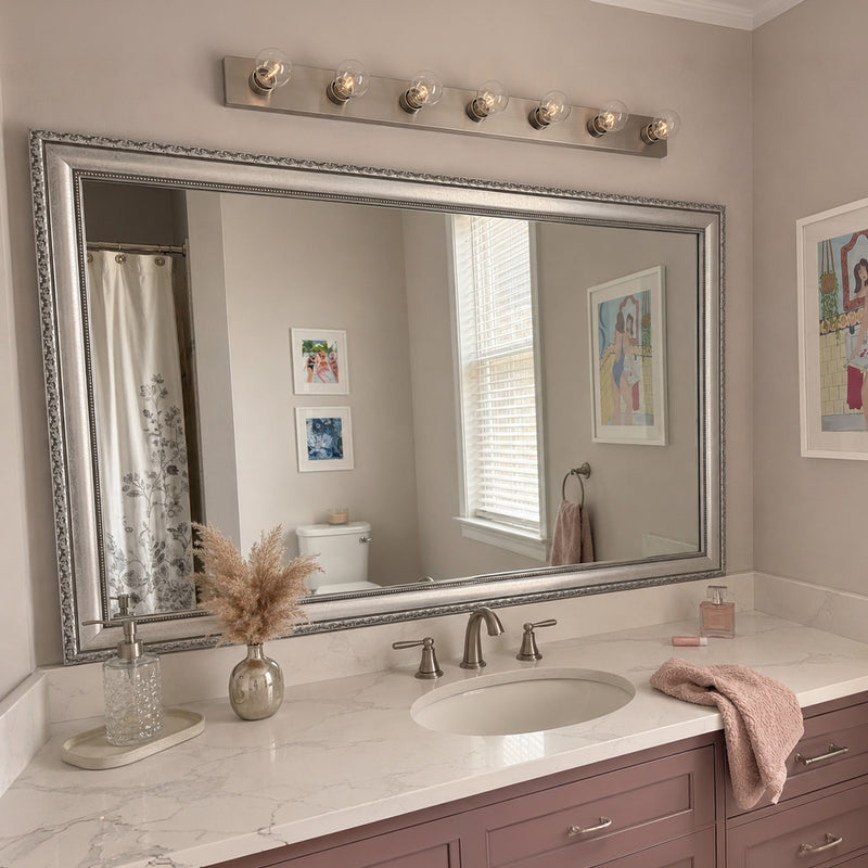 Bellemeade Vintage Silver MirrorMate frame above a blush single vanity in a glam bathroom