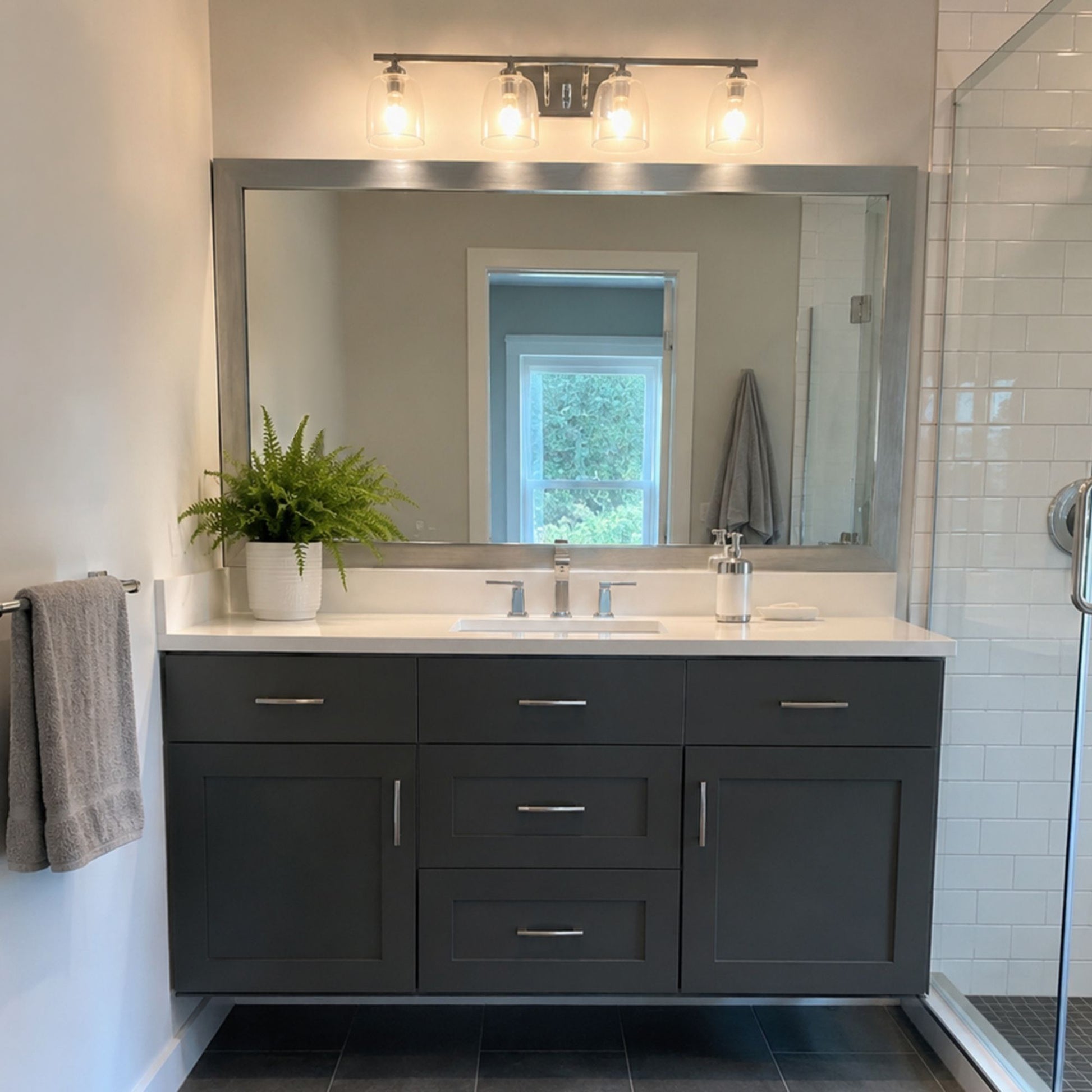 Broadway Brushed Chrome MirrorMate frame above a dark vanity in a modern bathroom