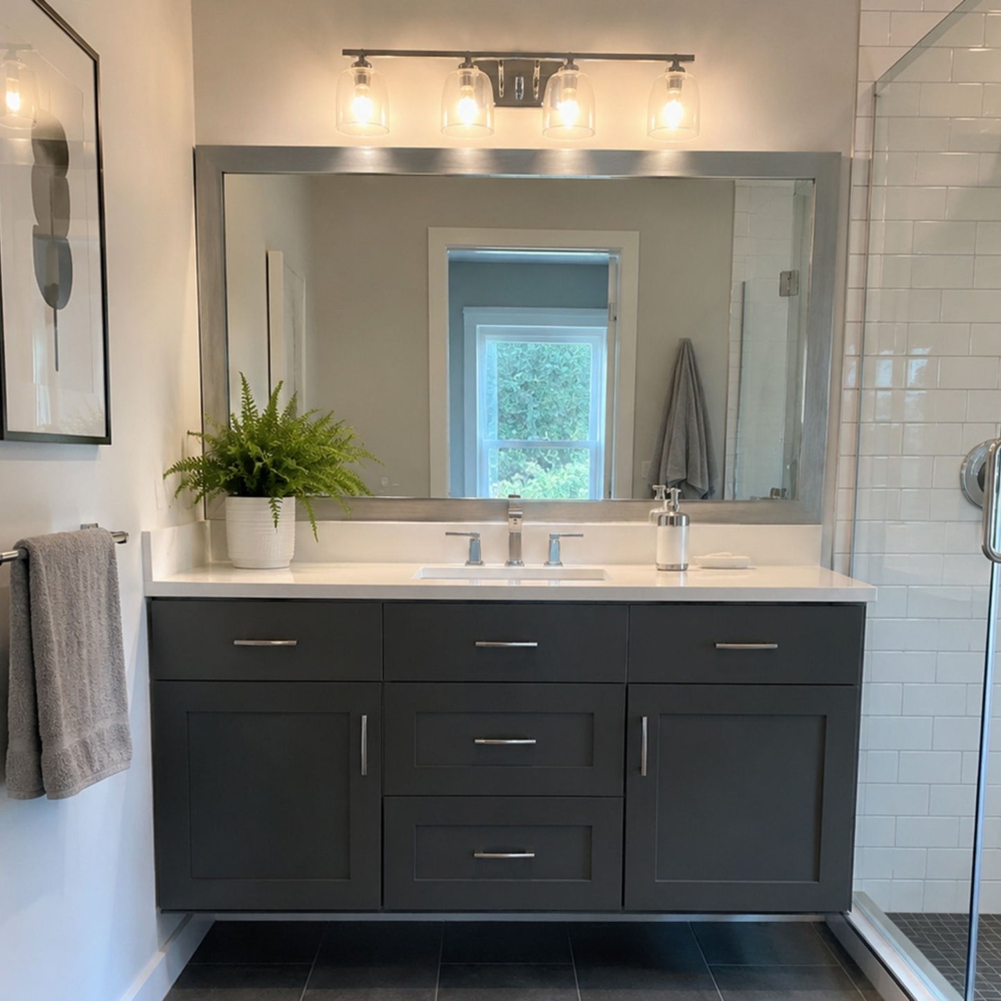 Broadway Brushed Chrome MirrorMate frame above a dark vanity in a modern bathroom