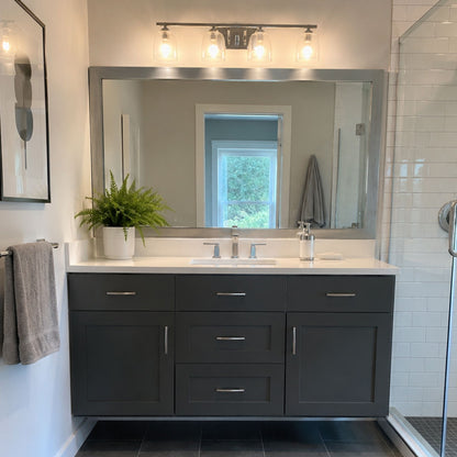 Broadway Brushed Chrome MirrorMate frame above a dark vanity in a modern bathroom