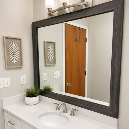 Cherokee Montauk Driftwood MirrorMate frame above a white bathroom vanity