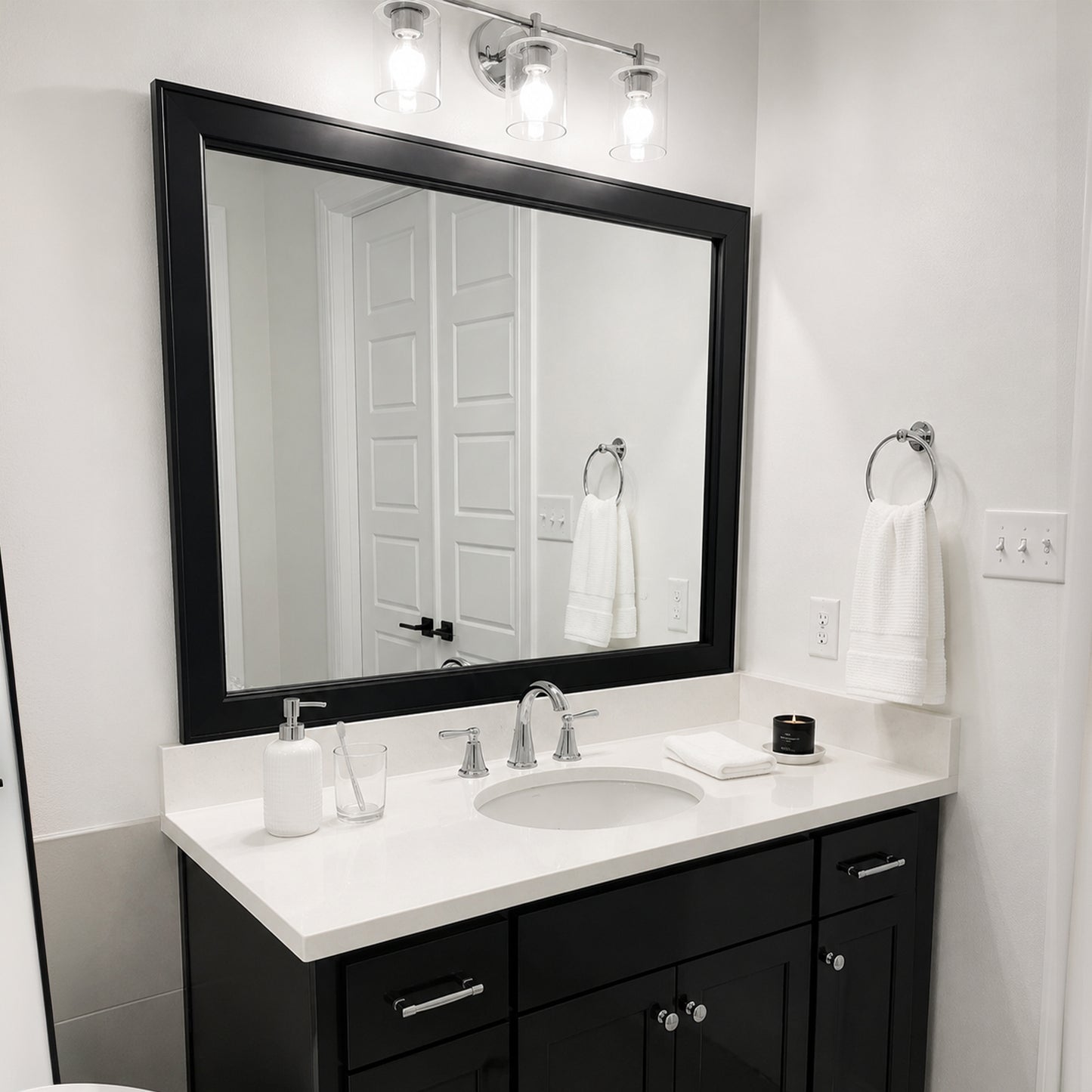 Essex Black Tie MirrorMate frame above a black single bathroom vanity