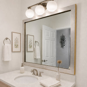 French Quarter Vintage Platinum MirrorMate frame above a white single bathroom vanity