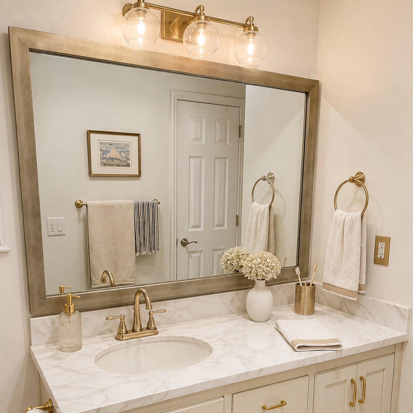 Highline Champagne Gold Slim MirrorMate bathroom mirror frame above a single vanity