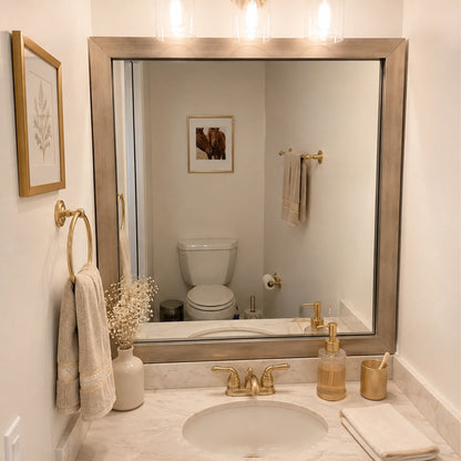 Highline Champagne Gold Slim MirrorMate bathroom mirror frame above a single vanity in a small bathroom