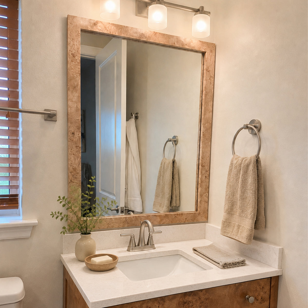 Highline Natural Burlwood Slim MirrorMate bathroom mirror frame above a single vanity in a warm neutral bathroom