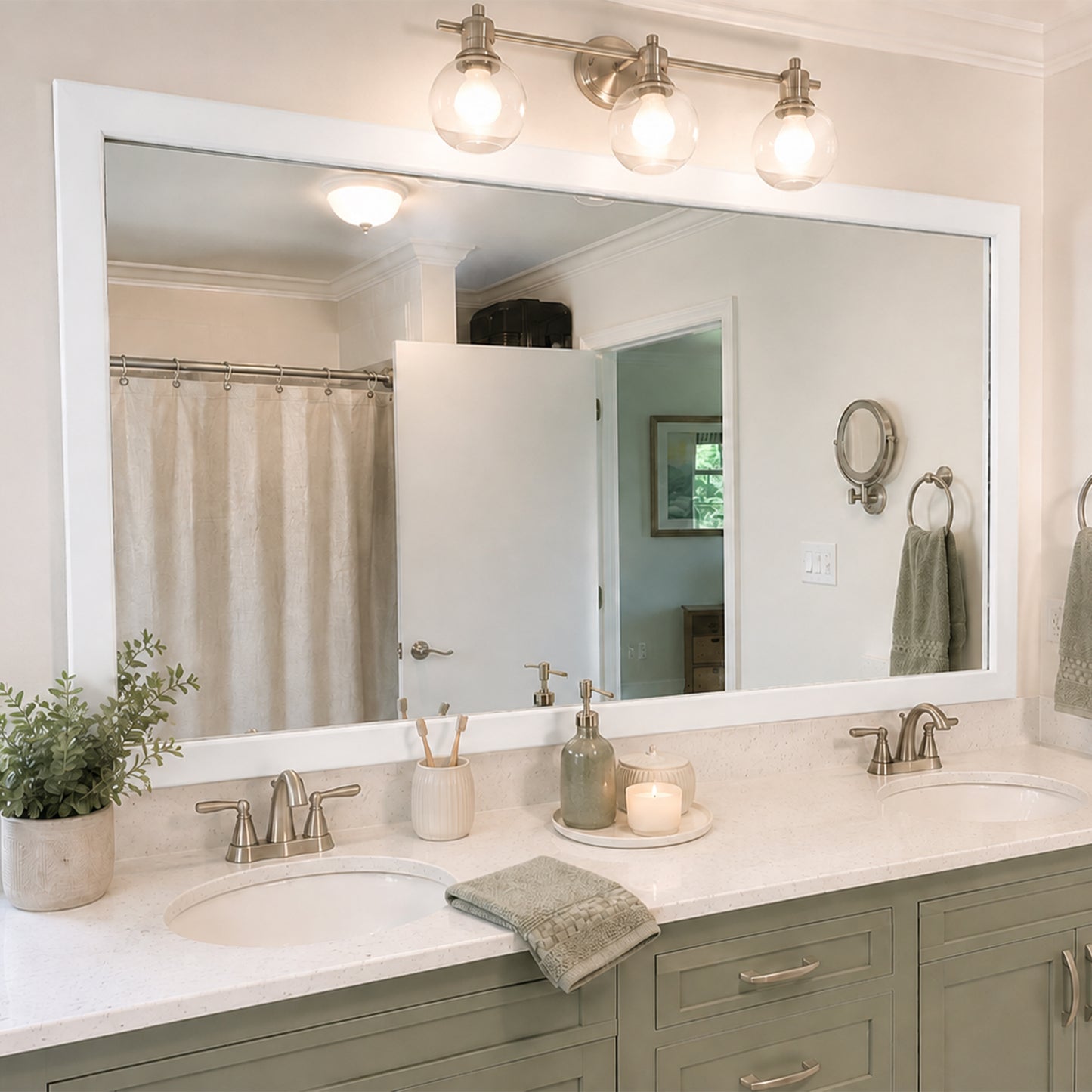 Highline Paintable Slim MirrorMate bathroom mirror frame above a sage green double vanity