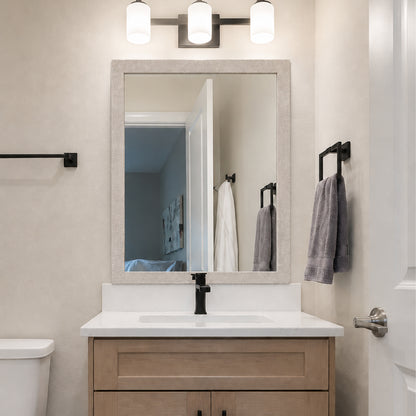 Highline Woven Silver Slim MirrorMate bathroom mirror frame above a light wood single vanity with black fixtures