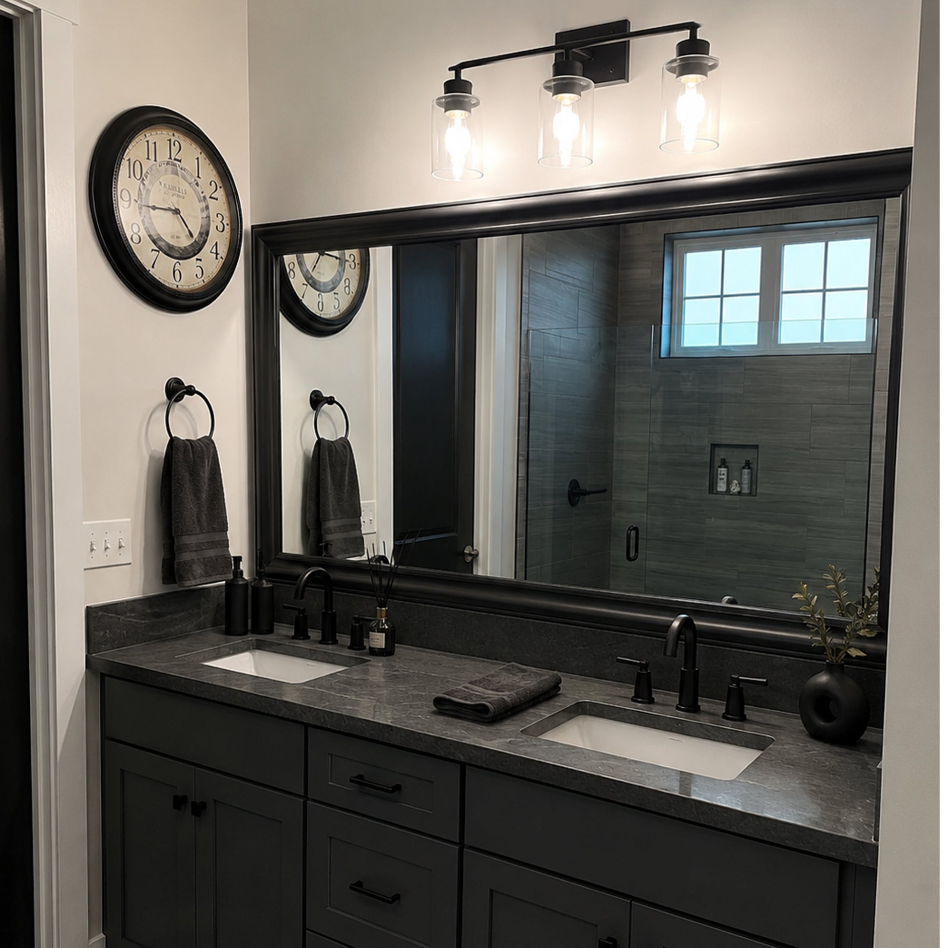 Hudson Midnight Steel MirrorMate bathroom mirror frame above a black double vanity in an industrial-style bathroom