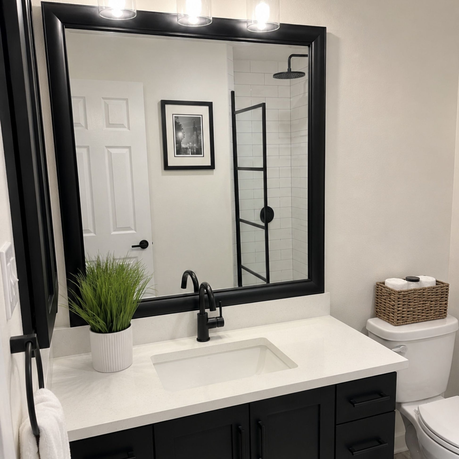Pemaquid Black Slim MirrorMate bathroom mirror frame above a black single vanity