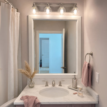 Soho Satin White MirrorMate bathroom mirror frame above a blush single vanity