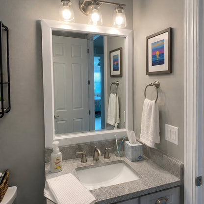 Soho Satin White MirrorMate bathroom mirror frame above a gray single vanity