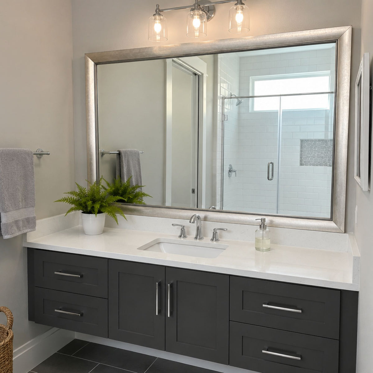 Solana Modern Silver MirrorMate bathroom mirror frame above a dark gray single vanity